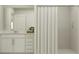 Well-lit bathroom featuring a white vanity and sink, with a shower enclosed by a modern striped curtain at 15083 Zircon Red Dr, Wimauma, FL 33598