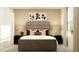 Stylish bedroom featuring a plush bed, elegant lamps, and contemporary decor at 15083 Zircon Red Dr, Wimauma, FL 33598