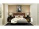 Cozy bedroom featuring a plush bed, stylish lamps, nightstands, and contemporary decor at 15083 Zircon Red Dr, Wimauma, FL 33598