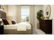 Tranquil bedroom with dresser, neutral decor, and a bright window at 15083 Zircon Red Dr, Wimauma, FL 33598