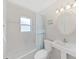 Clean bathroom with a tub, window, and white vanity at 16004 2Nd E St, Redington Beach, FL 33708