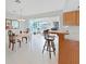 Dining area open to a bonus room and the kitchen, features a decorative light fixture at 16004 2Nd E St, Redington Beach, FL 33708