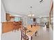 Open dining room with bar seating, a decorative chandelier, and plenty of natural light at 16004 2Nd E St, Redington Beach, FL 33708