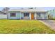 Charming single-story home showcasing a well-maintained lawn and a welcoming facade at 16004 2Nd E St, Redington Beach, FL 33708