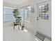 Bright sunroom showcasing tiled floors, a chair with decorative pillows, and natural light at 16004 2Nd E St, Redington Beach, FL 33708