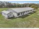 Aerial view of country home on a spacious lot surrounded by lush greenery at 2040 Underwood Ln, Zephyrhills, FL 33540