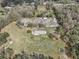 Expansive property featuring a long building surrounded by open space and scattered trees and greenery at 2040 Underwood Ln, Zephyrhills, FL 33540