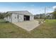 View of the barn featuring a spacious patio area perfect for outdoor entertaining or enjoying serene country views at 2040 Underwood Ln, Zephyrhills, FL 33540