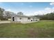 Exterior of barn featuring green lawn and stone-paved patio at 2040 Underwood Ln, Zephyrhills, FL 33540