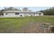 Rear exterior of barn with grass lawn and stone-paved patio at 2040 Underwood Ln, Zephyrhills, FL 33540