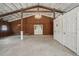 Barn interior features concrete flooring, wooden structure, and chandeliers at 2040 Underwood Ln, Zephyrhills, FL 33540