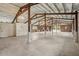 Vast barn interior with concrete floors, high ceilings, and exposed timber beams at 2040 Underwood Ln, Zephyrhills, FL 33540