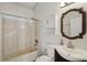 Bathroom features a shower-tub combination and modern vanity with decorative mirror at 2040 Underwood Ln, Zephyrhills, FL 33540