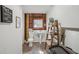 Unique rustic half-bathroom with wood accent wall, pedestal sink, decorative ladder, and all essential amenities at 2040 Underwood Ln, Zephyrhills, FL 33540