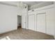 Spacious bedroom boasts wood-look flooring, modern light fixture and double closets at 2040 Underwood Ln, Zephyrhills, FL 33540