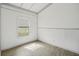 Bright bedroom features wood-look flooring, white wainscoting and large window at 2040 Underwood Ln, Zephyrhills, FL 33540