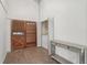 Well-lit entryway with wood-look tile flooring, coat closet and decorative console, perfect drop zone at 2040 Underwood Ln, Zephyrhills, FL 33540