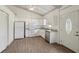 Bright, efficient kitchen featuring white cabinetry, stainless steel appliances, and wood-look tile flooring at 2040 Underwood Ln, Zephyrhills, FL 33540