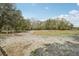 Expansive land featuring sandy soil, mature trees, and partially fenced perimeter at 2040 Underwood Ln, Zephyrhills, FL 33540
