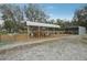 Goat and sheep pens including metal shelters, with metal fencing, and grazing areas at 2040 Underwood Ln, Zephyrhills, FL 33540