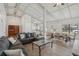 Bright and airy living room featuring a large dining area and adjacent kitchen with stainless steel appliances at 2040 Underwood Ln, Zephyrhills, FL 33540