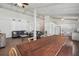 Open living space with wood-look tile flooring connecting the living room, dining area, and kitchen at 2040 Underwood Ln, Zephyrhills, FL 33540