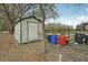 Backyard storage shed offers practical space, with trash cans and a water barrel nearby at 2040 Underwood Ln, Zephyrhills, FL 33540