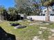 Exterior shot of the backyard showing garden beds, privacy fence, shed, and tropical landscaping at 2656 44Th S St, Gulfport, FL 33711