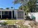 Backyard featuring a storage shed, garden beds, tropical landscaping, and a white privacy fence at 2656 44Th S St, Gulfport, FL 33711