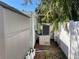 Exterior side shot of the AC unit with white privacy fence at 2656 44Th S St, Gulfport, FL 33711