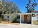 Charming single-story home with a vibrant orange front door and well-maintained landscaping at 2656 44Th S St, Gulfport, FL 33711
