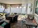Enclosed lanai featuring a dining table set, wicker furniture, brick floors and access to the home's outdoor space at 2656 44Th S St, Gulfport, FL 33711