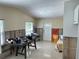 Living room showcasing terrazzo flooring, large window, and front door at 2656 44Th S St, Gulfport, FL 33711