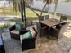 Covered porch with dining table, wicker furniture, and outdoor access at 2656 44Th S St, Gulfport, FL 33711