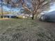 Lush backyard with mature trees and green grass, perfect for outdoor activities and relaxation at 2765 Countryside Blvd # 106, Clearwater, FL 33761