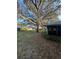 View of the grassy backyard with established landscaping around the homes at 2765 Countryside Blvd # 106, Clearwater, FL 33761