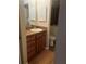 Bathroom featuring wood cabinets and granite countertops at 2765 Countryside Blvd # 106, Clearwater, FL 33761