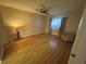 Cozy bedroom with hardwood floors, ceiling fan, and natural light at 2765 Countryside Blvd # 106, Clearwater, FL 33761
