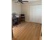 Bedroom featuring light filled windows, wood look floors and a closet at 2765 Countryside Blvd # 106, Clearwater, FL 33761