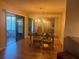 Inviting dining area with hardwood floors, sliding glass doors, and a large mirror accent at 2765 Countryside Blvd # 106, Clearwater, FL 33761