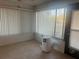 Bright Florida Room with large windows and neutral tile flooring, offering serene views and natural light at 2765 Countryside Blvd # 106, Clearwater, FL 33761