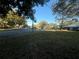 Expansive front lawn, lined with mature trees and a view of the neighborhood at 2765 Countryside Blvd # 106, Clearwater, FL 33761