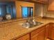Kitchen featuring granite countertops and stainless steel sink at 2765 Countryside Blvd # 106, Clearwater, FL 33761