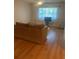 Bright living room featuring hardwood floors, and a large window at 2765 Countryside Blvd # 106, Clearwater, FL 33761