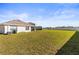 Wide shot of spacious fenced backyard with view of home's exterior at 2839 Gumbo Limbo Dr, Wimauma, FL 33598