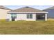 Back view of home's exterior and spacious fenced backyard at 2839 Gumbo Limbo Dr, Wimauma, FL 33598
