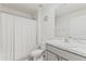 A clean, well-lit bathroom featuring a shower with curtain, toilet, and vanity with countertop at 2839 Gumbo Limbo Dr, Wimauma, FL 33598