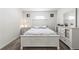 Bright bedroom with a white wooden bed frame, matching dresser, and neutral-toned carpet at 2839 Gumbo Limbo Dr, Wimauma, FL 33598