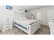 Bright bedroom with white wood bedroom set, carpet flooring, and an attached bathroom at 2839 Gumbo Limbo Dr, Wimauma, FL 33598