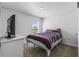 Bedroom with a large window and a bed with red, white, and blue striped blanket at 2839 Gumbo Limbo Dr, Wimauma, FL 33598